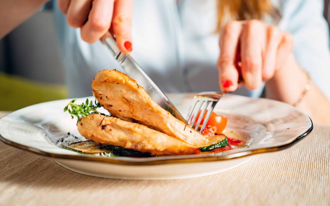 woman eating grilled chicken breast
